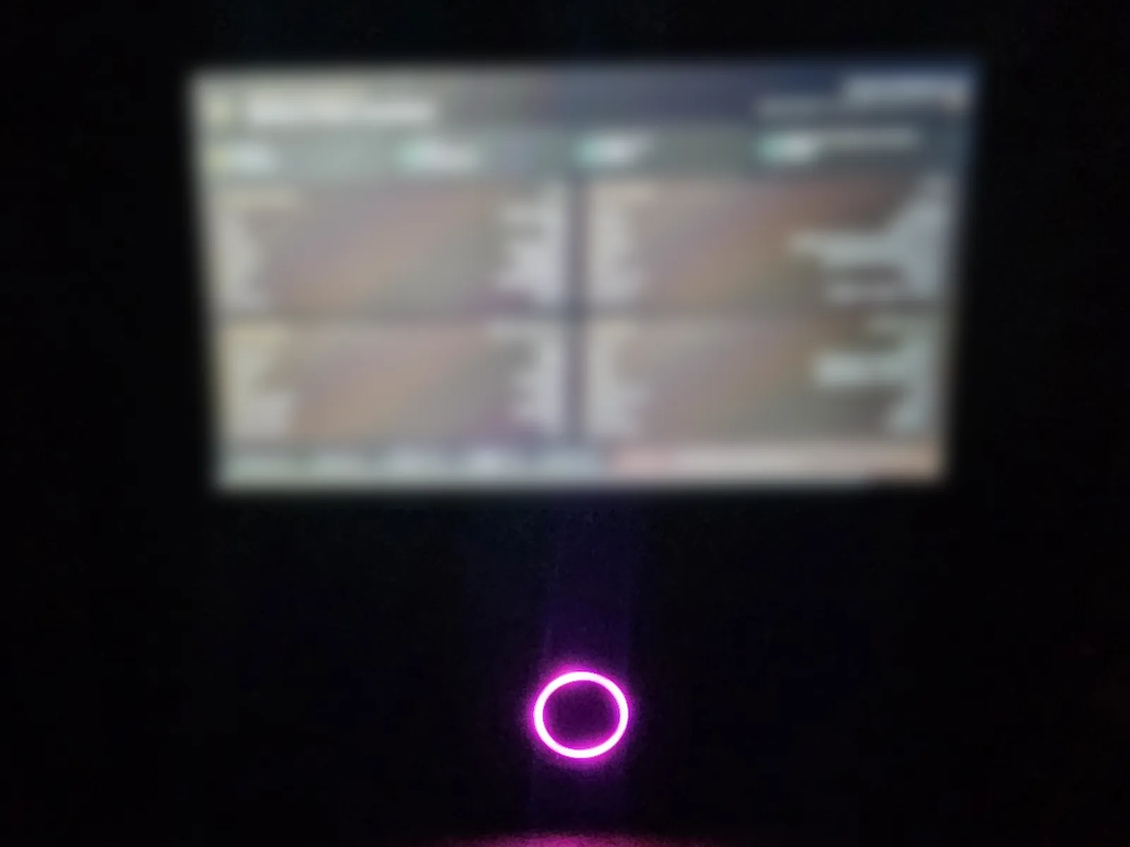 Finished assembled QRelia Pulse terminal with a purple fingerprint ring and device diagnostics on screen
