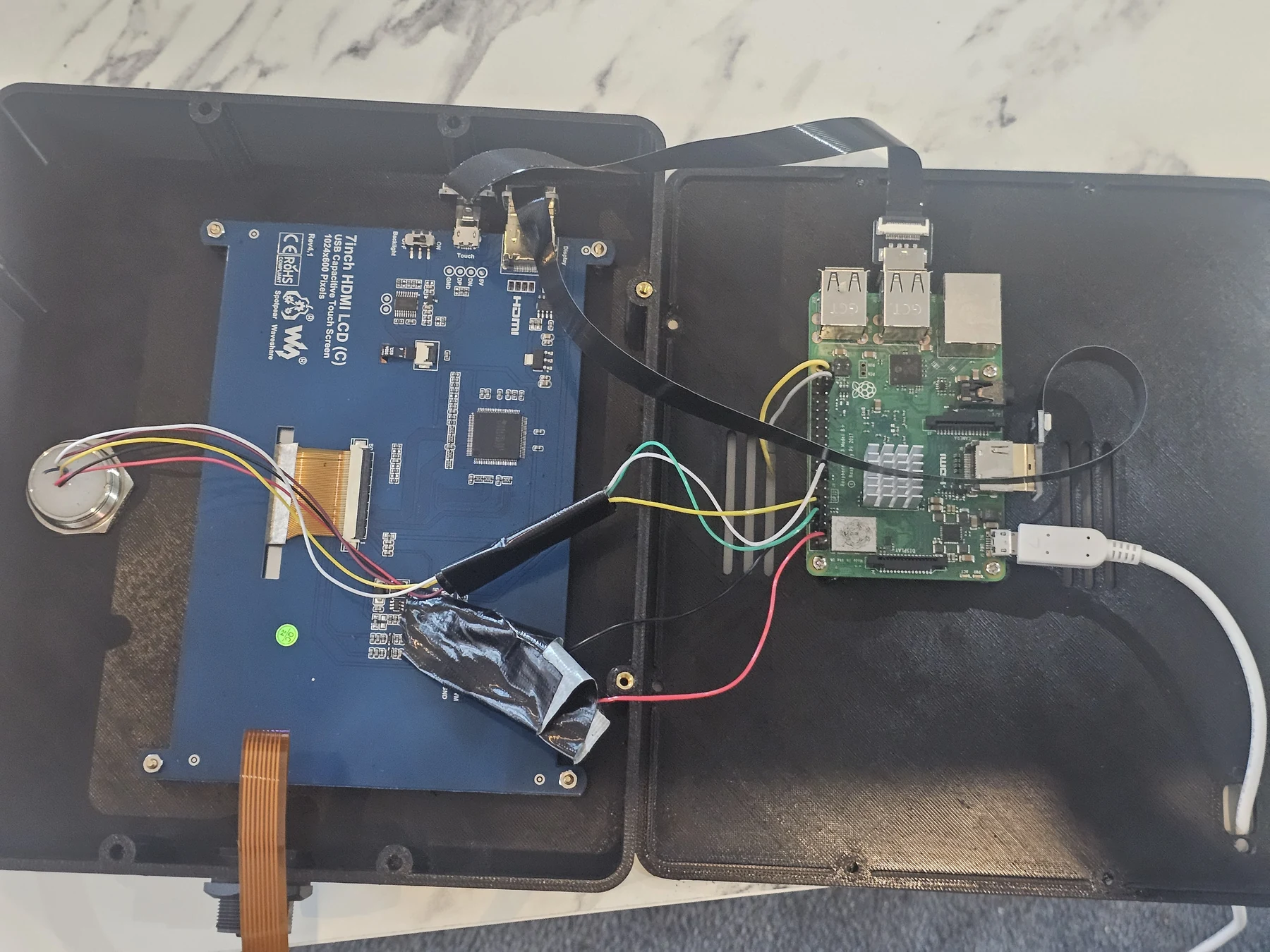 Opened QRelia Pulse enclosure showing the screen controller, Raspberry Pi and internal wiring