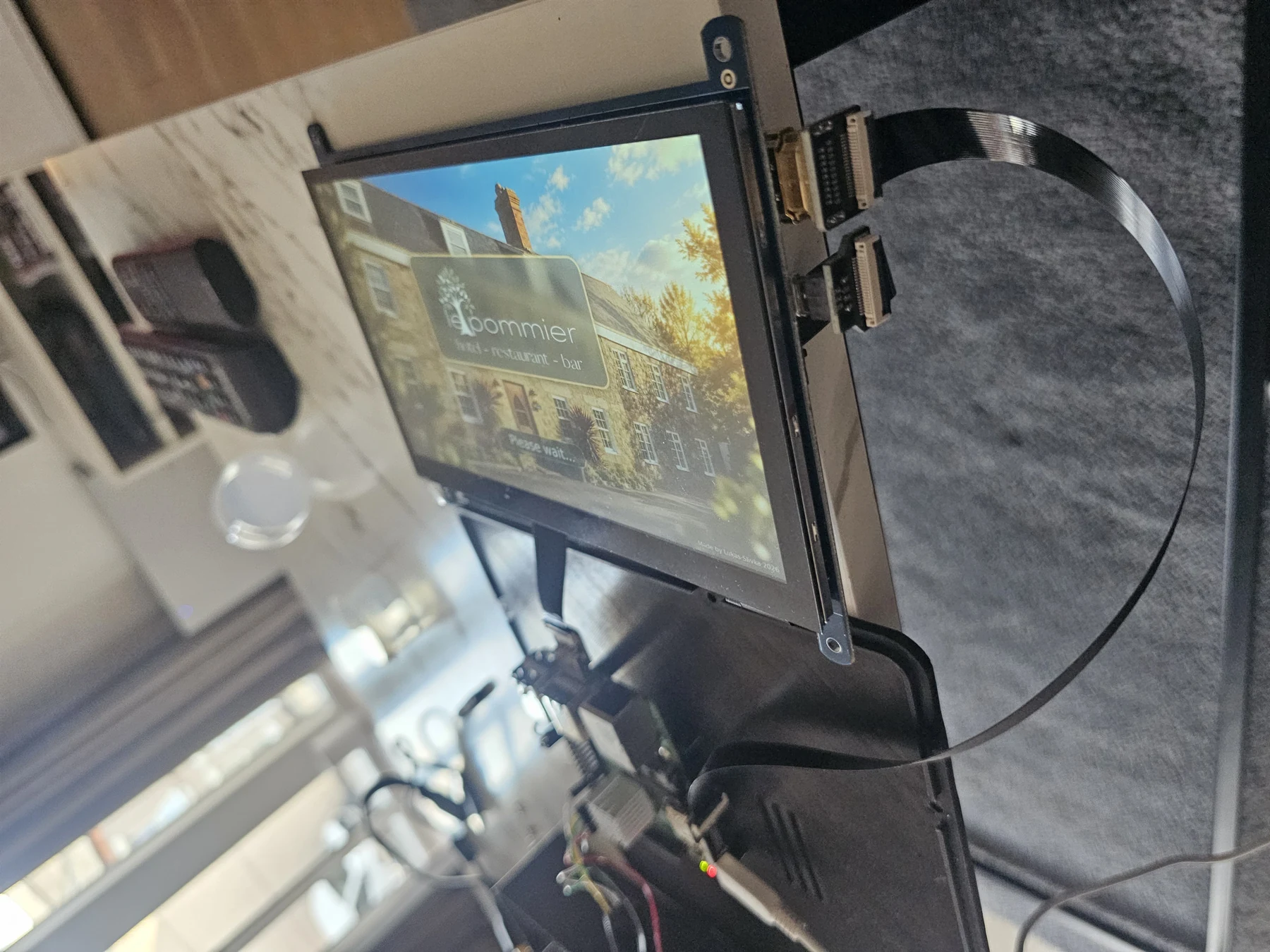 Actual QRelia Pulse hardware in development, showing the screen assembly and embedded build