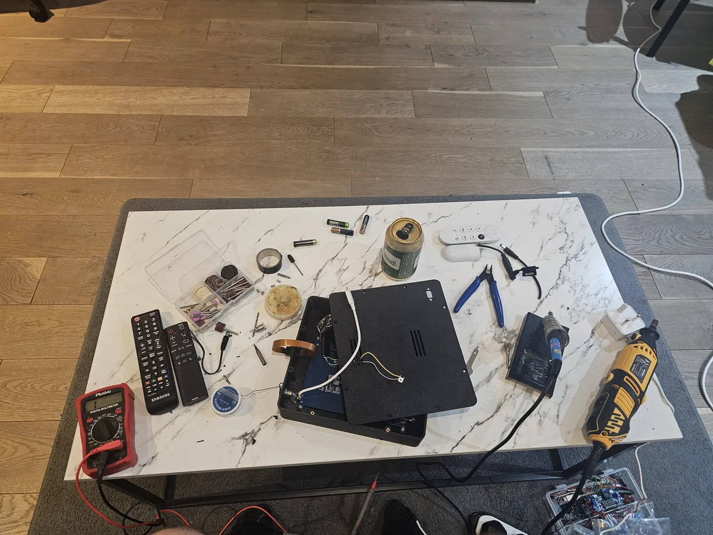 Workbench with terminal housing and tools during assembly